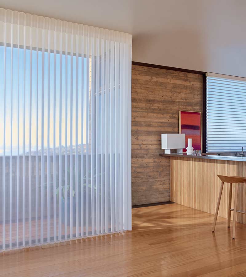 white sheer shades for patio doors in kitchen with light wood floor and bar Removing Vertical Blinds