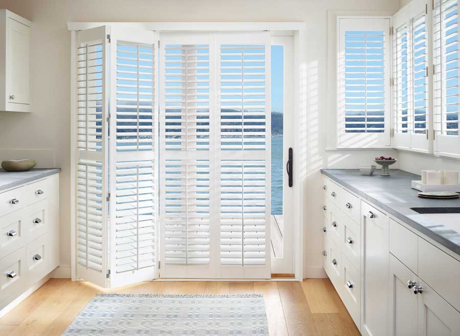 white bi fold plantation shutters leading to patio