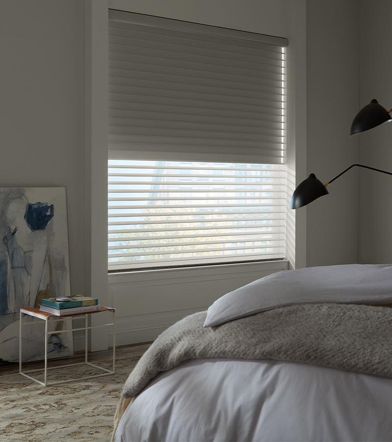 room-darkening-bedroom-blackout-shades-hunter-douglas-custom-shades-of-ontario Bright living room featuring light-filtering Sonnette® shades on window above window seat