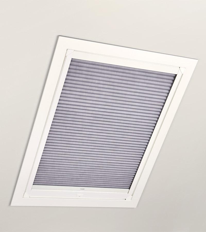 skylight window in gray with white trim in bedroom