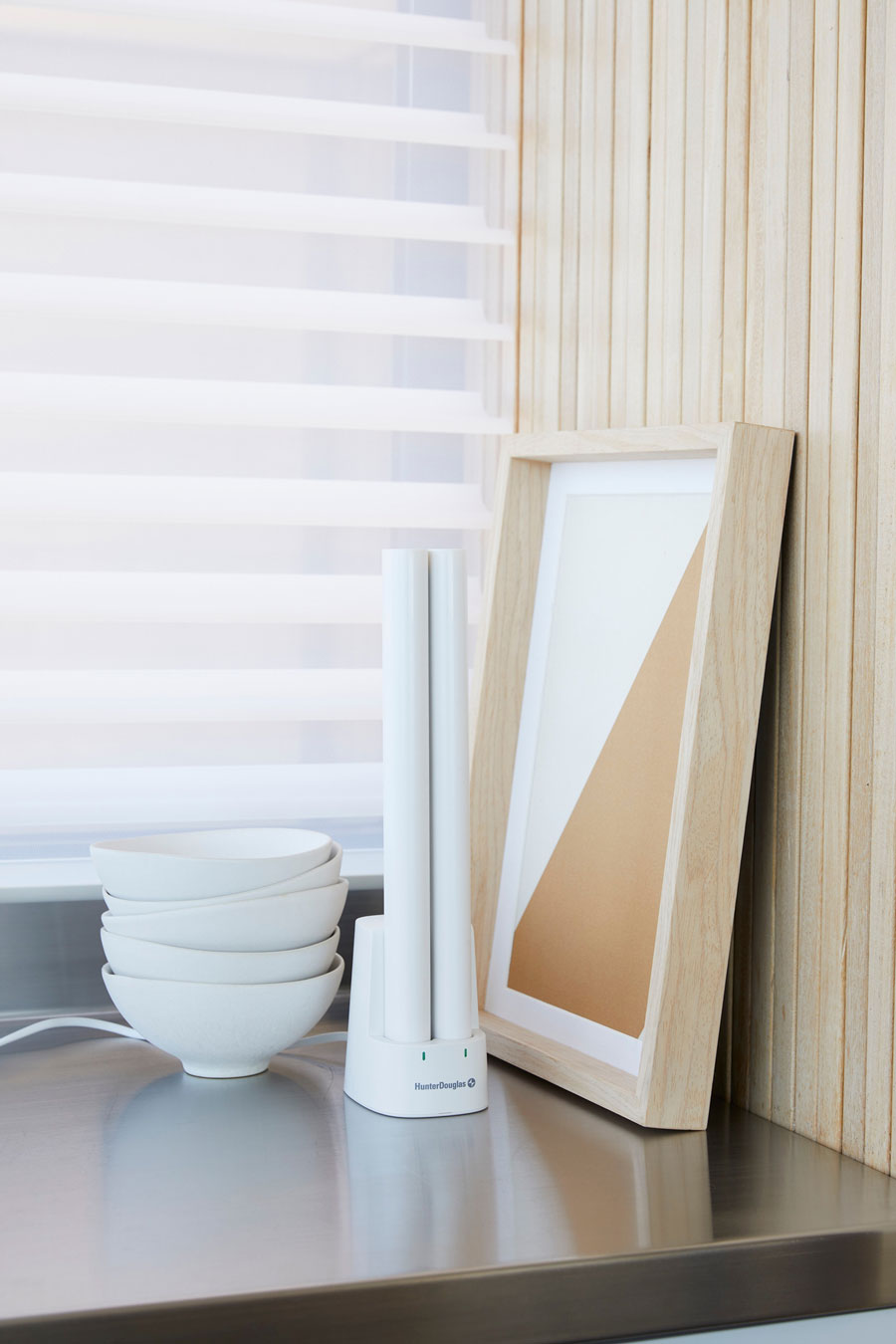 Rechargeable battery wands for motorized shades in a charging station