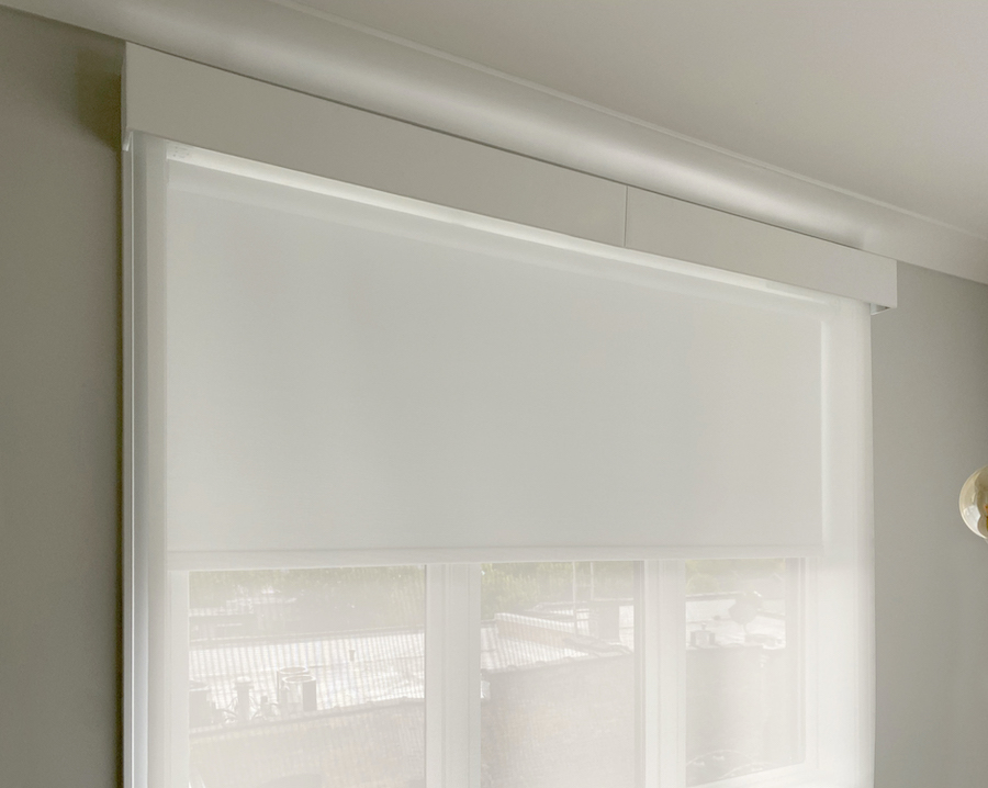 white motorized roller shades powered by a rechargeable battery wand